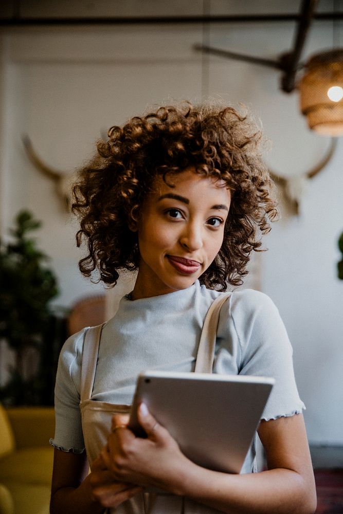 Cheerful woman holding a digital tablet in her arm