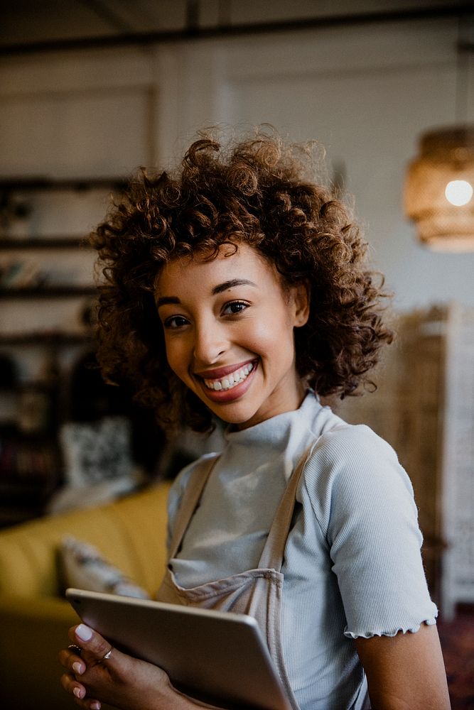 Cheerful woman holding a digital tablet in her arm