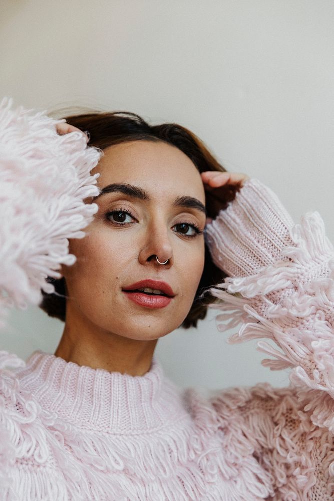 Portrait of a cheerful woman in a light pink sweater