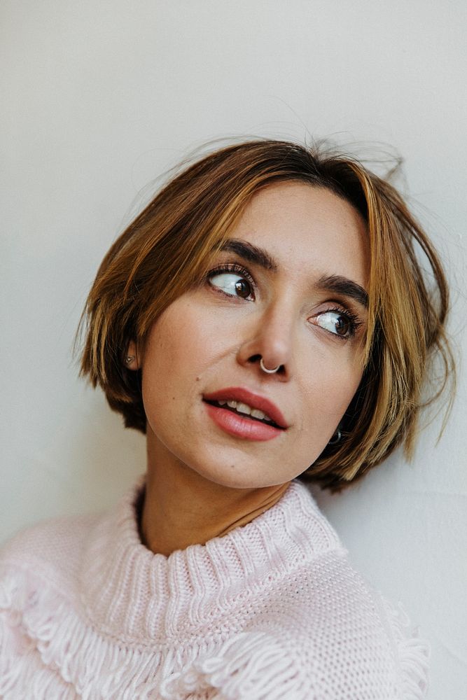 Portrait of a cheerful woman in a light pink sweater