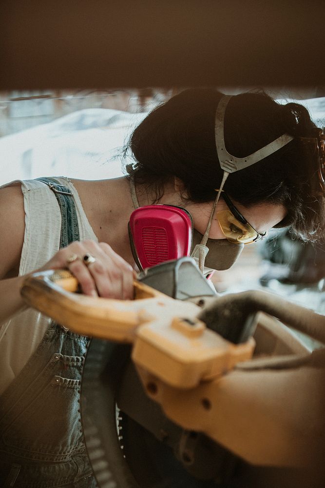 Female carpenter using a compound miter saw