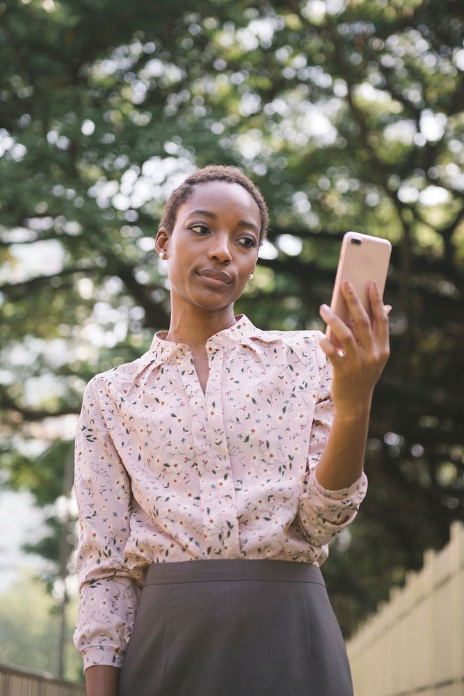 Upset black lady looking at her phone