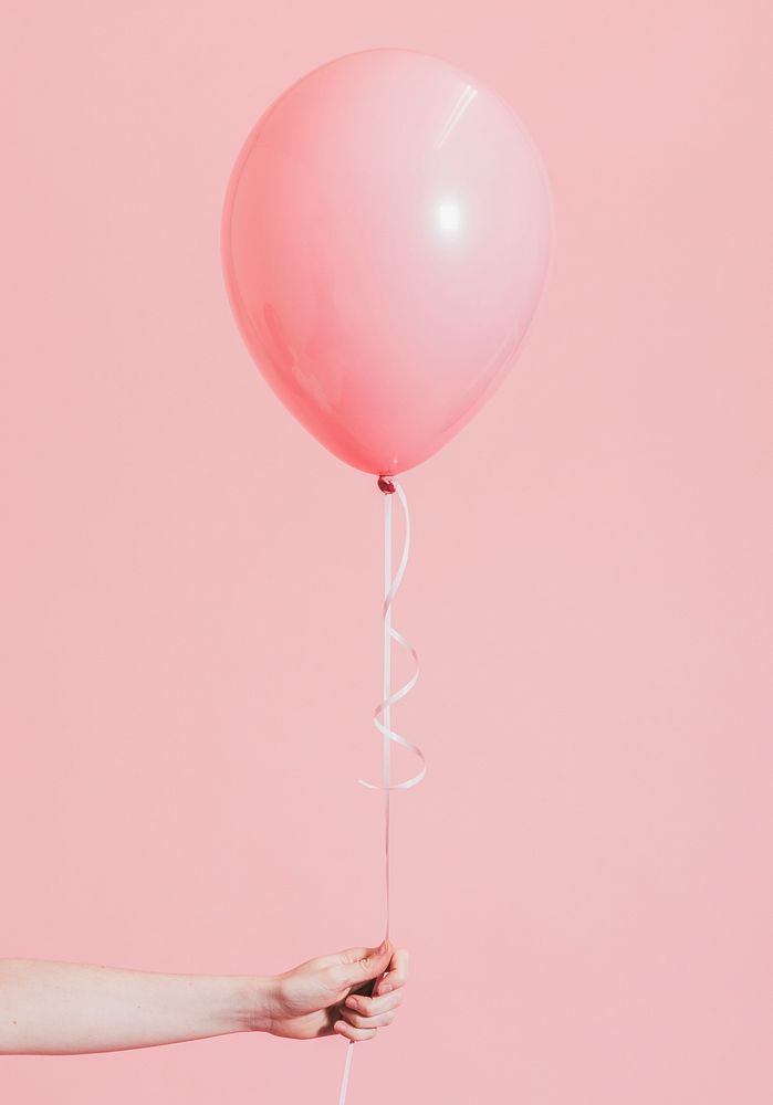 Woman holding a pink balloon