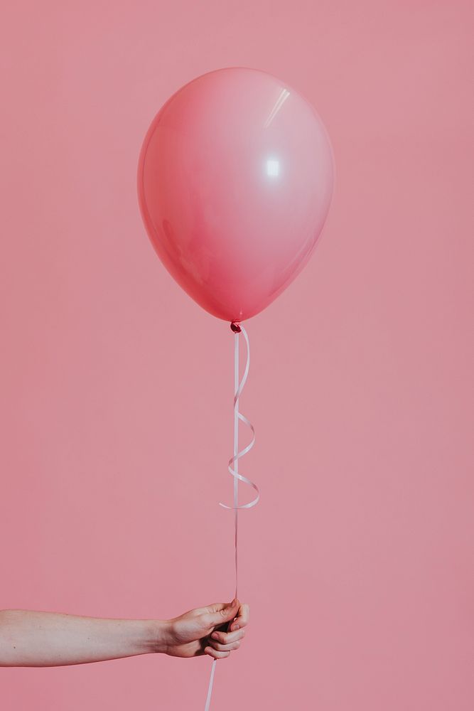Woman holding a pink balloon