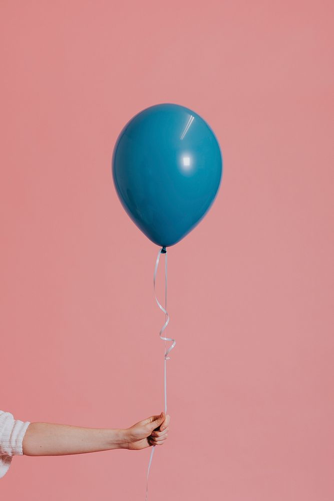Girl holding a pastel blue balloon