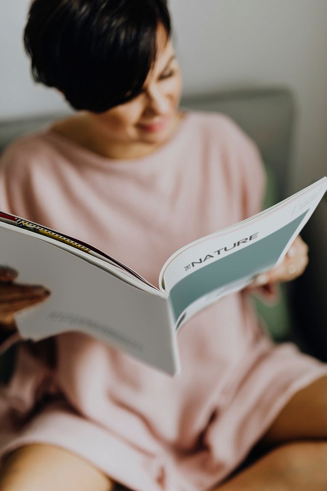 Happy woman reading a magazine