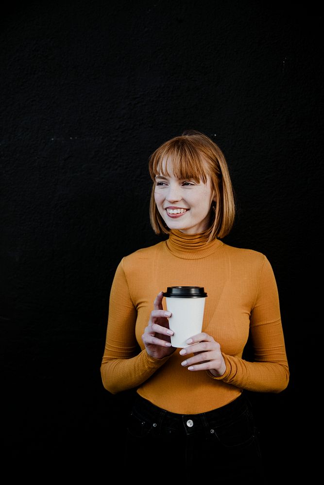 Woman wearing a turtleneck with a takeout paper cup mockup