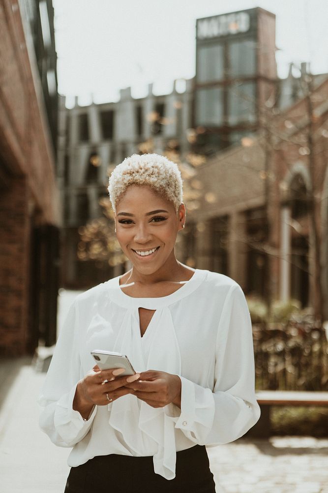 Happy black woman using her smartphone