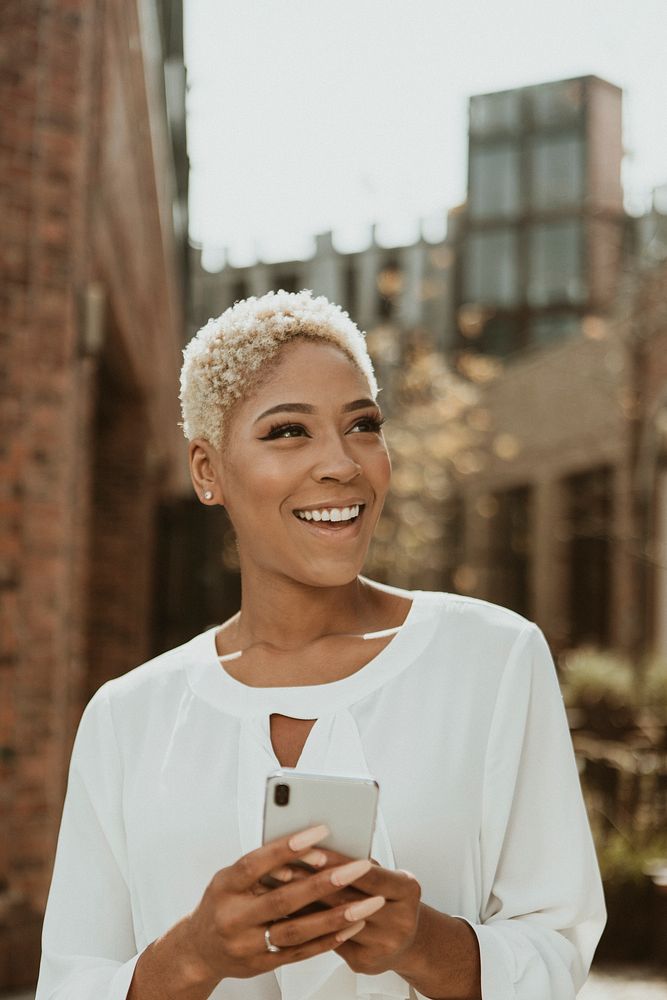 Happy black woman using her smartphone