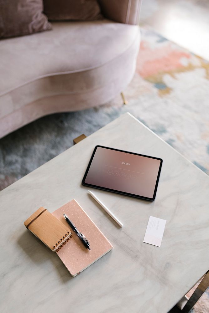 Digital tablet on a white marble table in a living room