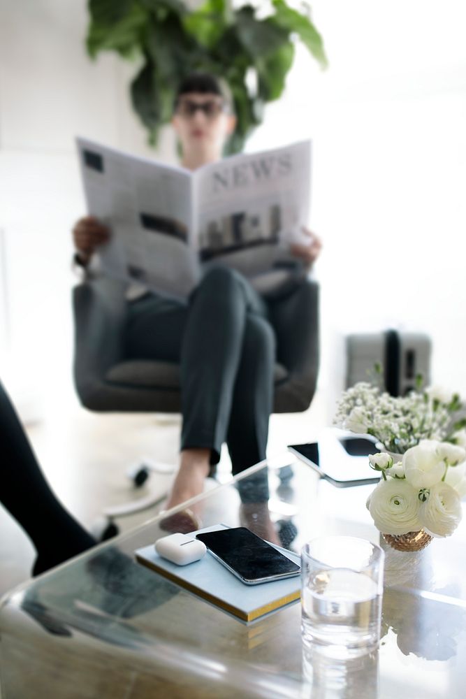 Young businesswoman reading a newspaper