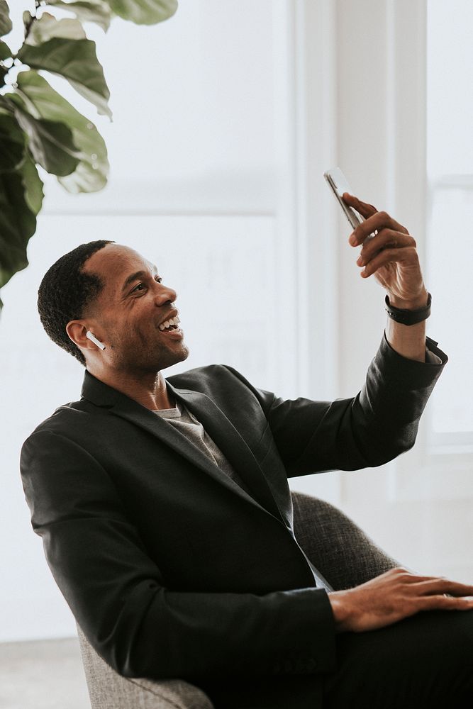 African American man with earphones video calling