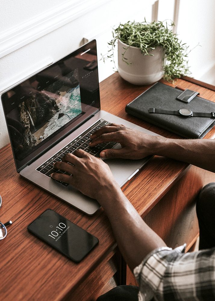 Black male blogger using a laptop