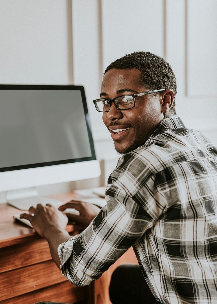 Black man typing on a keyboard