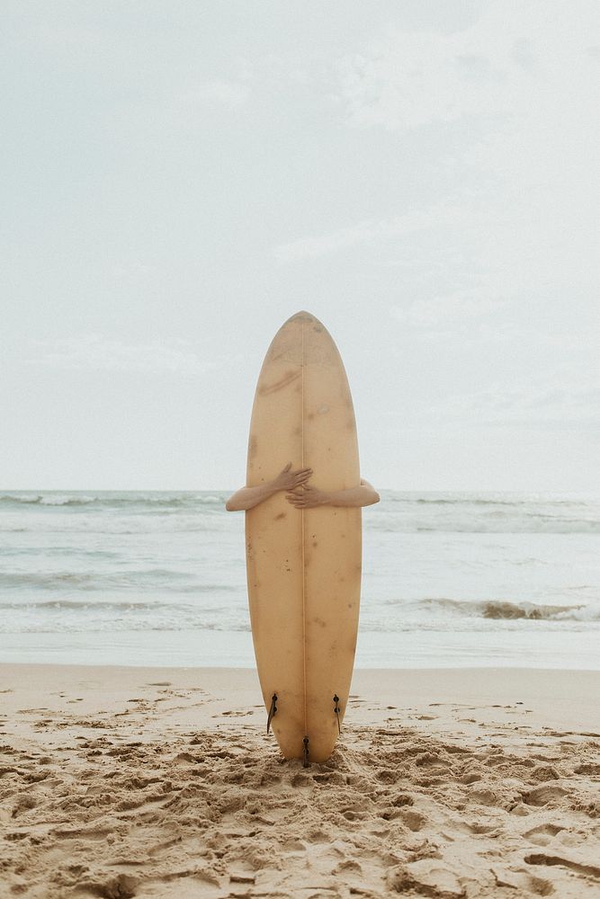 Surfer hugging a surfboard mockup