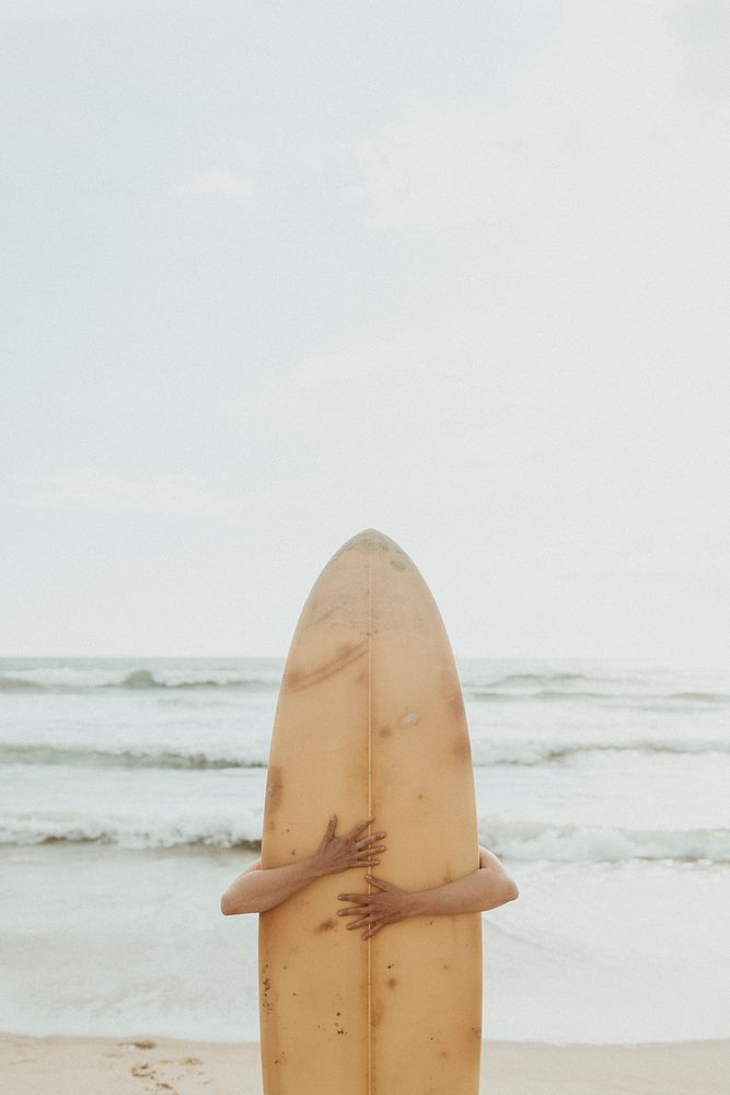 Surfer hugging a surfboard mockup