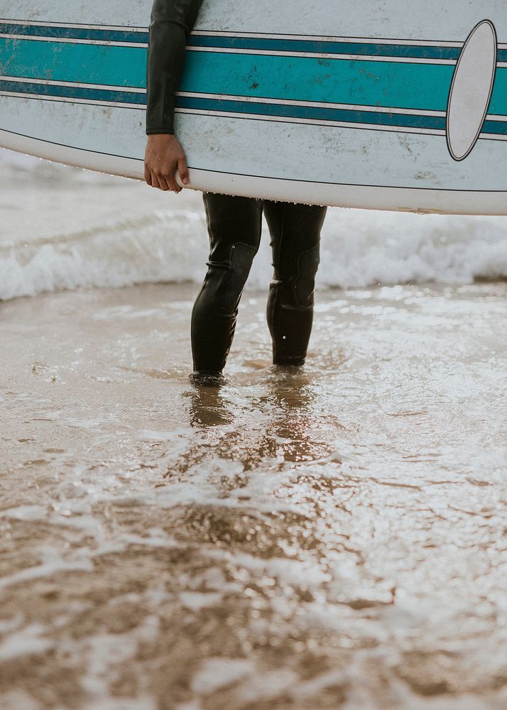 Man at the beach with his surfboard