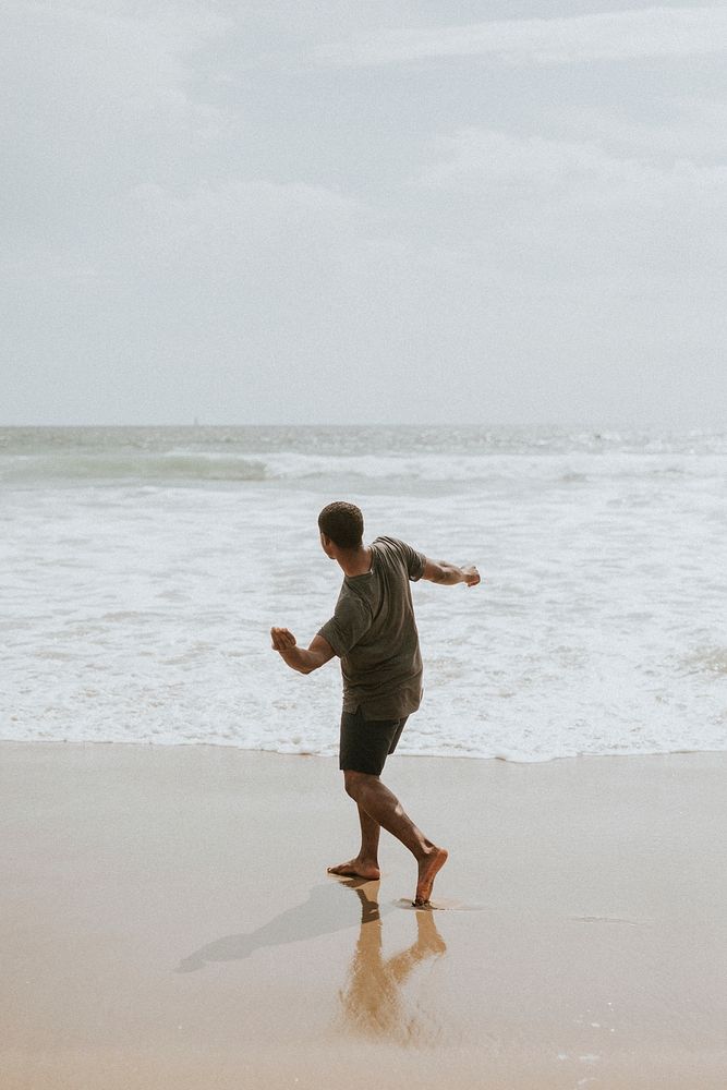 Man throwing a stone into the sea