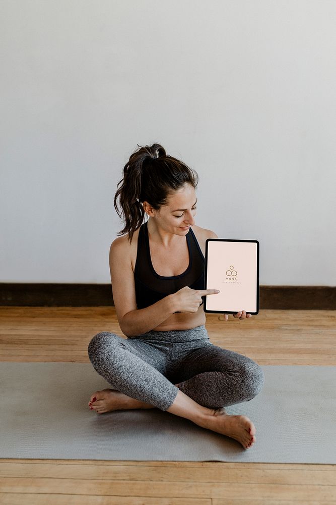 Yoga instructor showing a digital tablet