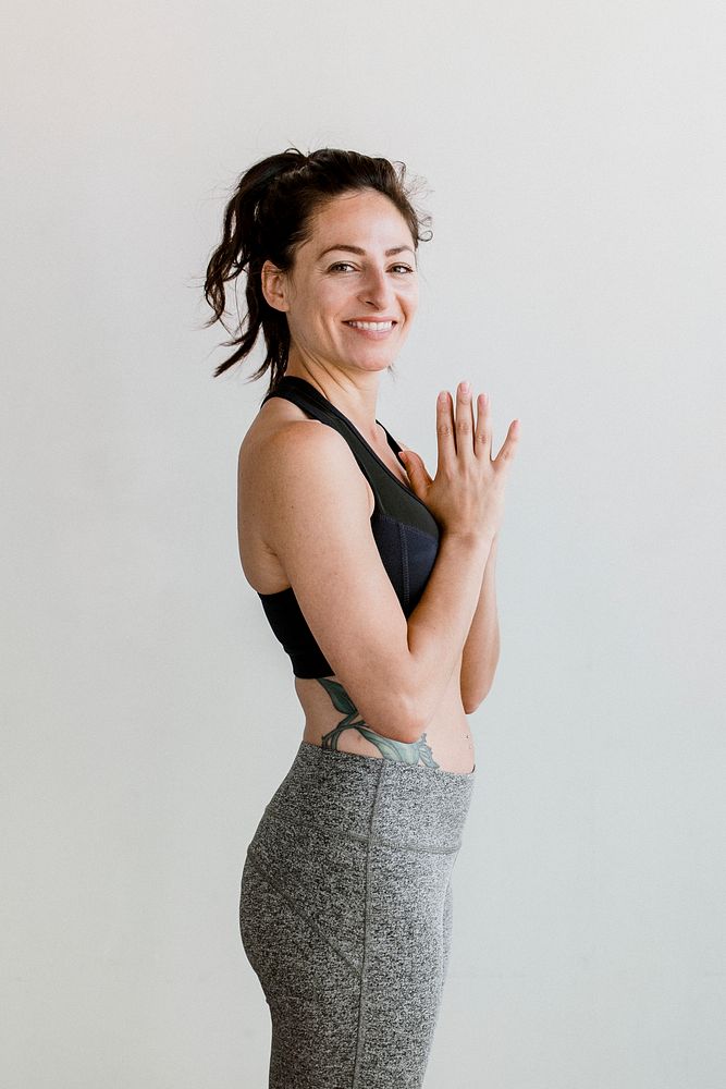 Sporty woman in Anjali Mudra pose