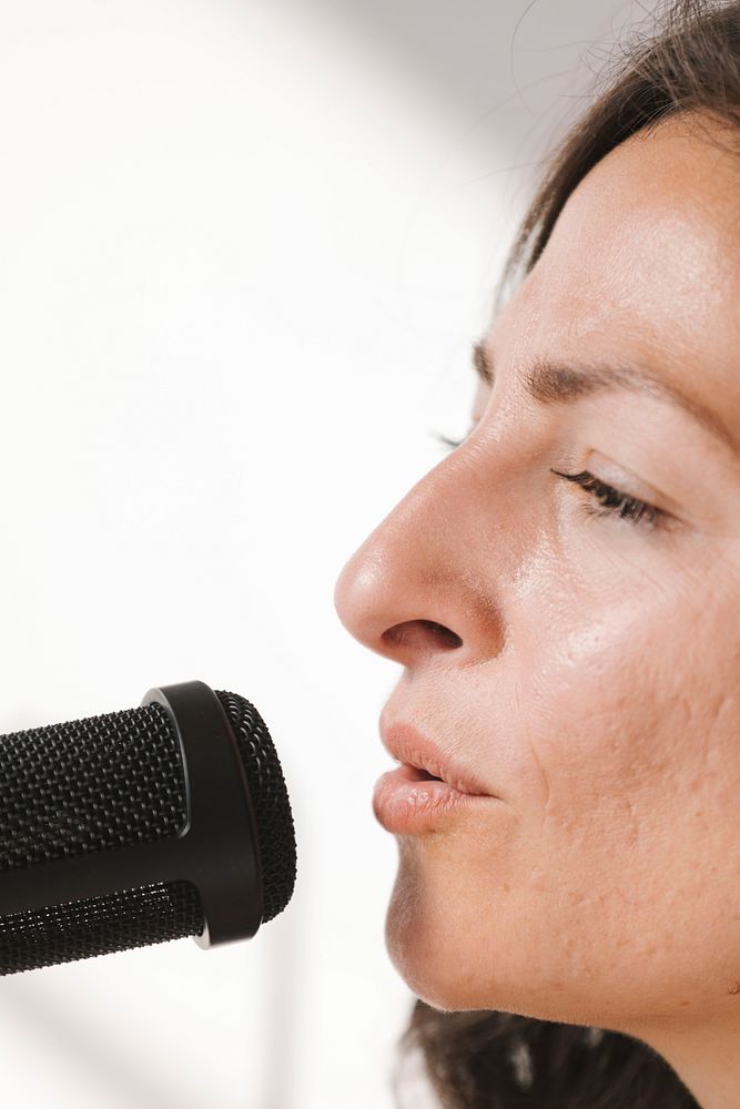 Female singer singing live in a studio