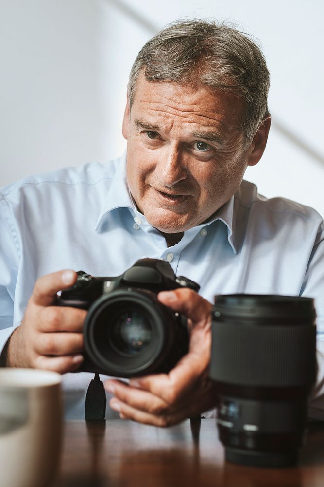 Senior photographer using a camera in a studio
