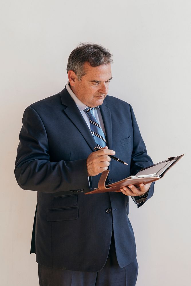 Businessman writing on a planner