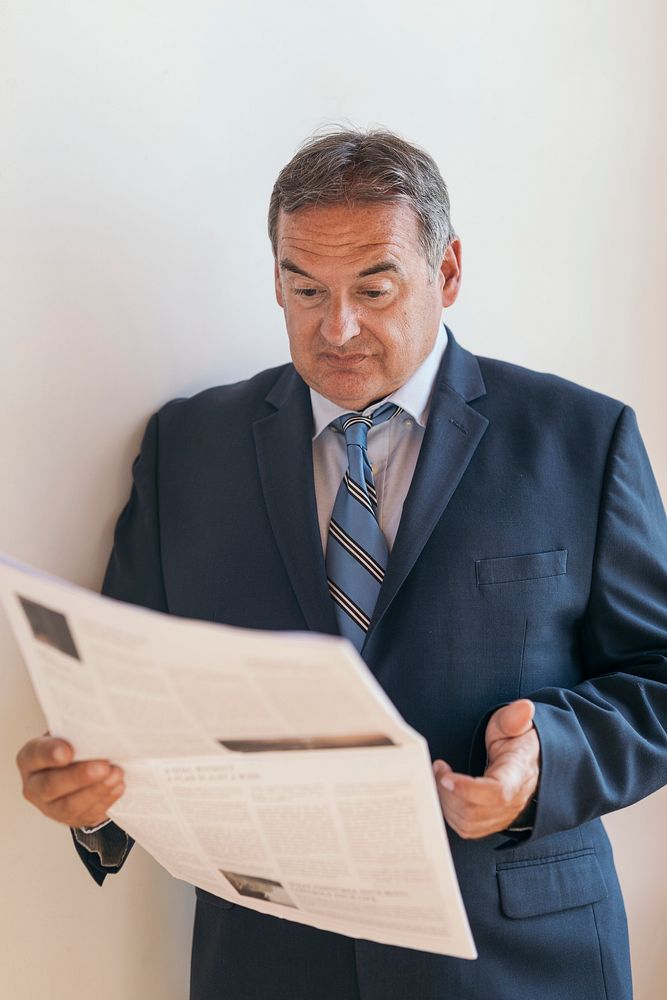 CEO reading the morning newspaper