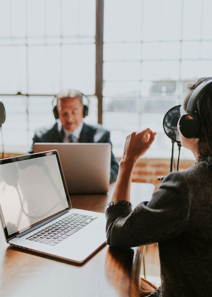 Female broadcaster interviewing her guest in a studio