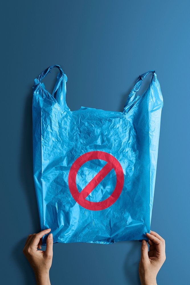 Woman holding a blue plastic bag mockup with a ban sign