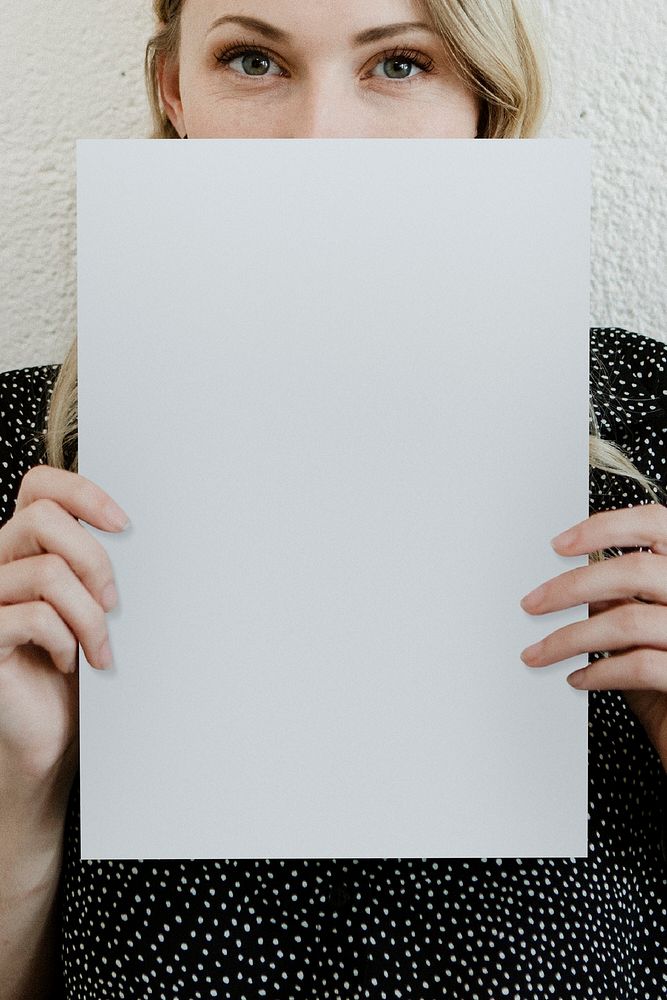 Blond woman showing a blank white poster mockup