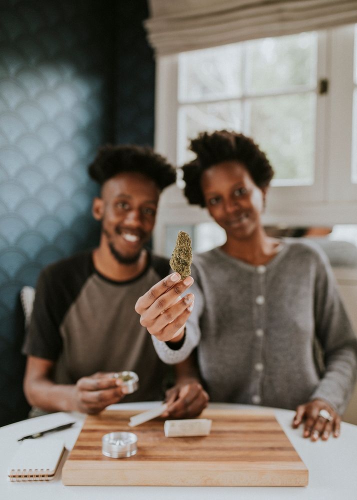 A couple rolling a joint