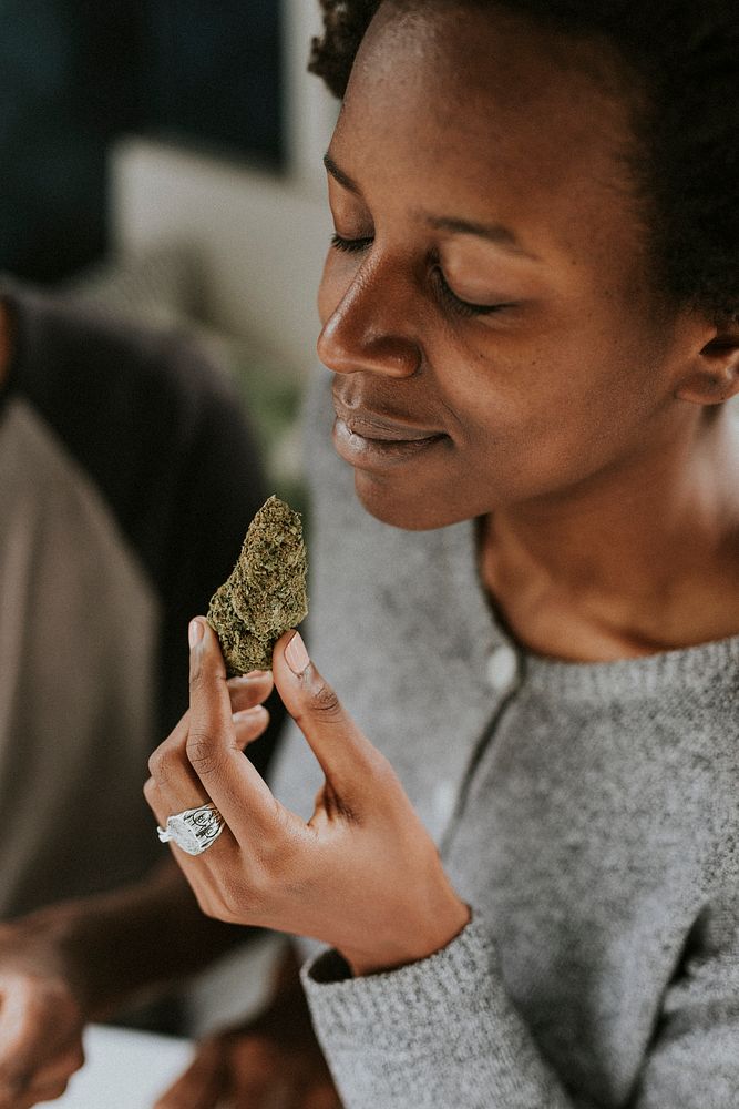 Woman holding weed in hand