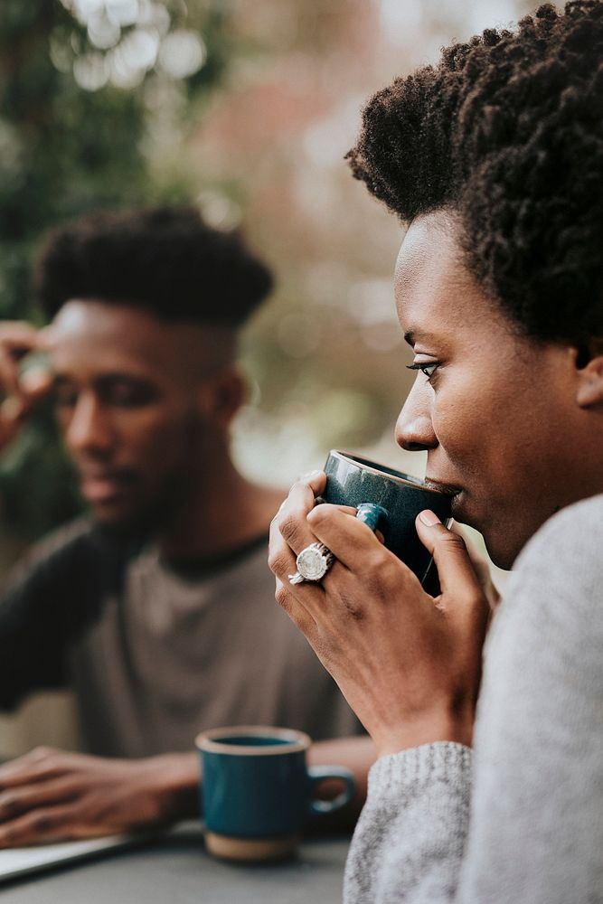Black couple drinking coffee in the garden