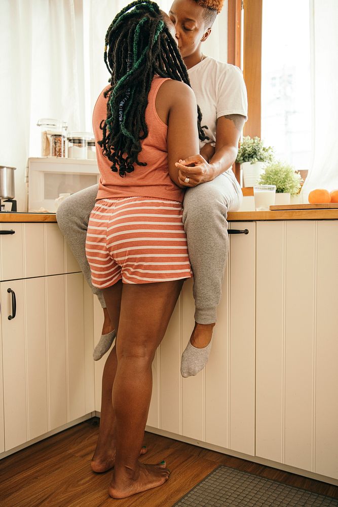 Happy gay couple kissing in the kitchen