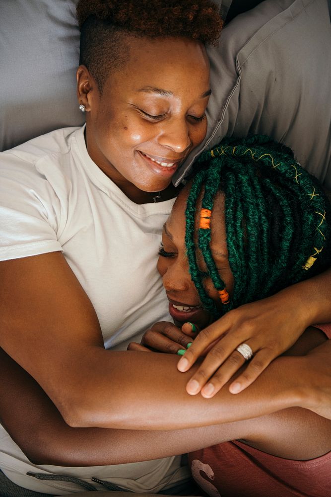 Happy lesbian lovers in bed