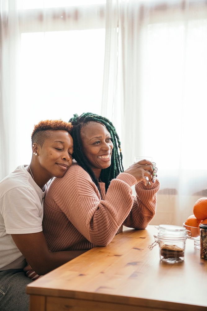 Romantic lesbian couple cuddling table | Premium Photo - rawpixel