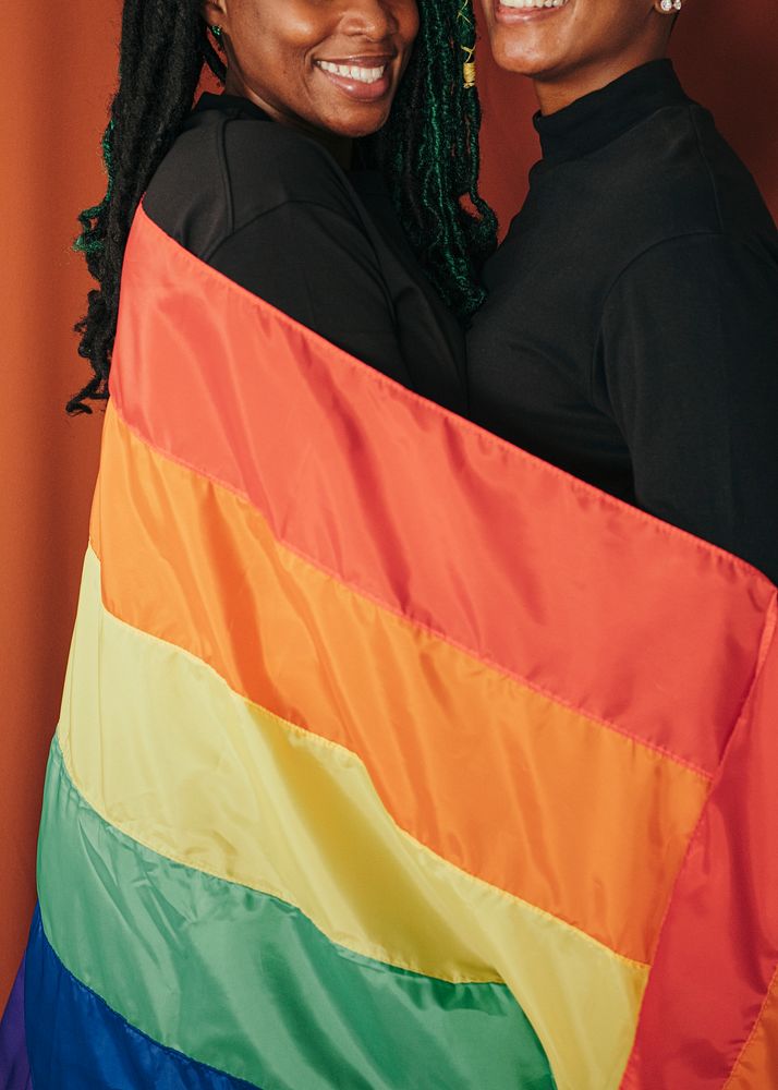 Happy lesbian couple with a colorful flag