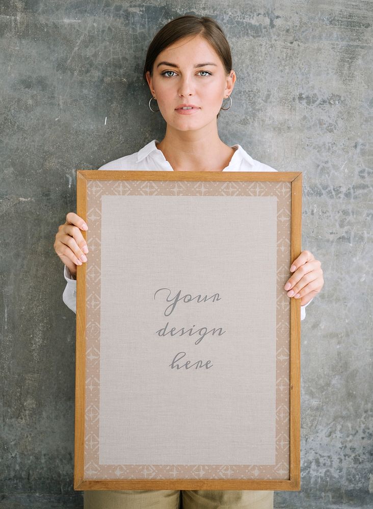 Woman holding a blank wooden photo frame mockup
