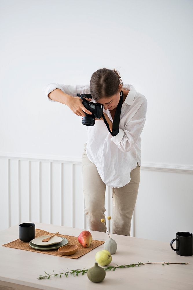 Blogger photographing the plate decor on the dining table
