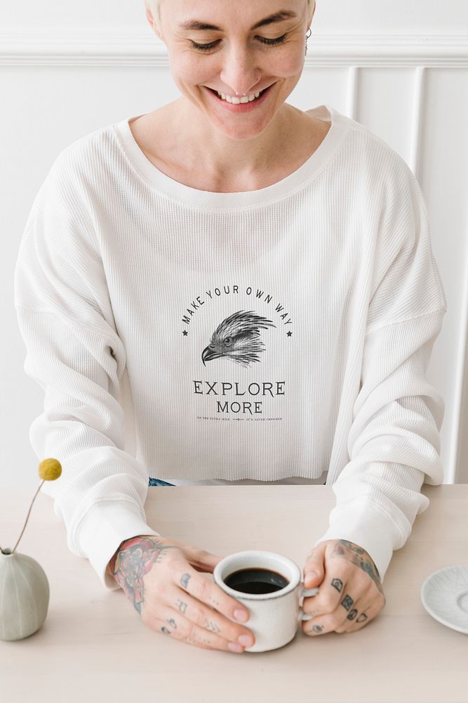 Smiling tattooed woman having a cup coffee mockup