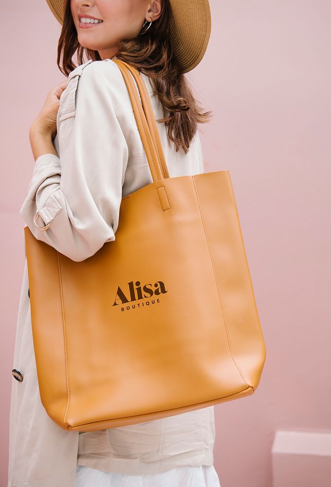 Woman carrying a brown handbag mockup