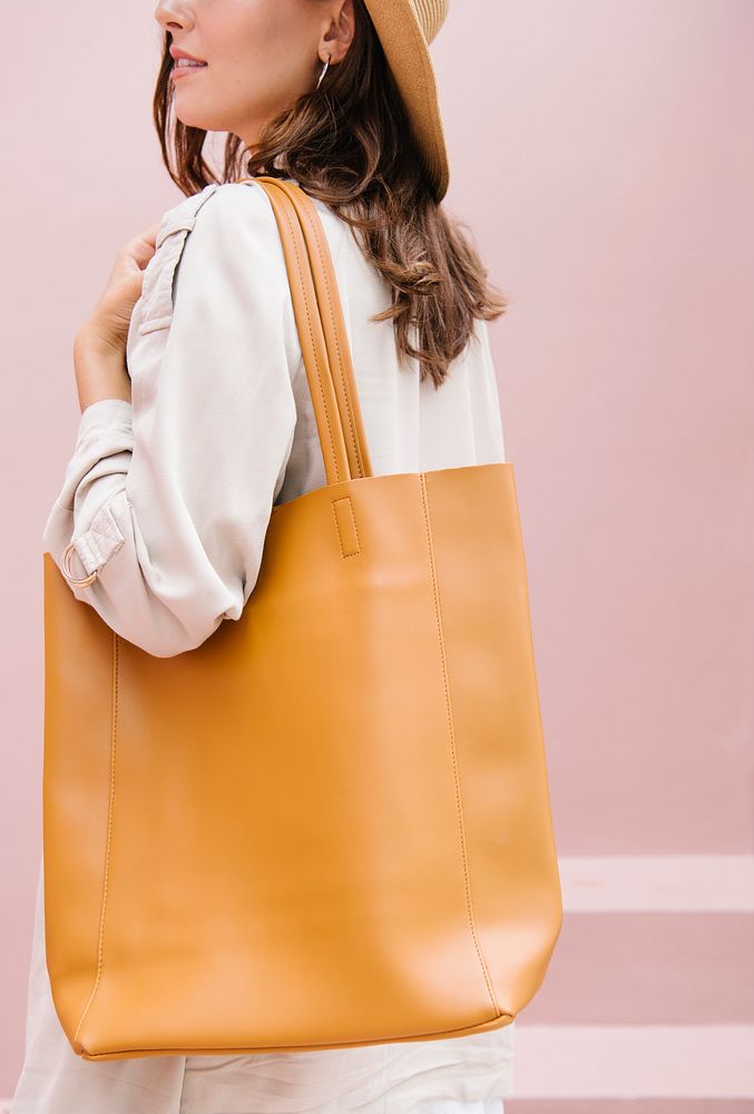 Woman in a beige coat with her brown tote bag