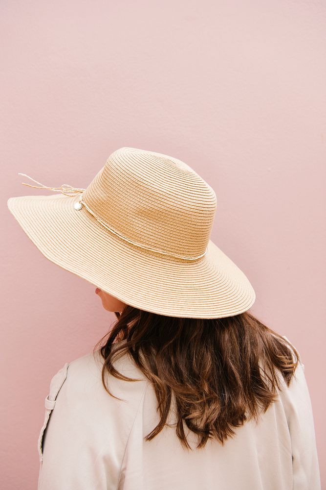 Rearview of a brown hair woman in a woven hat