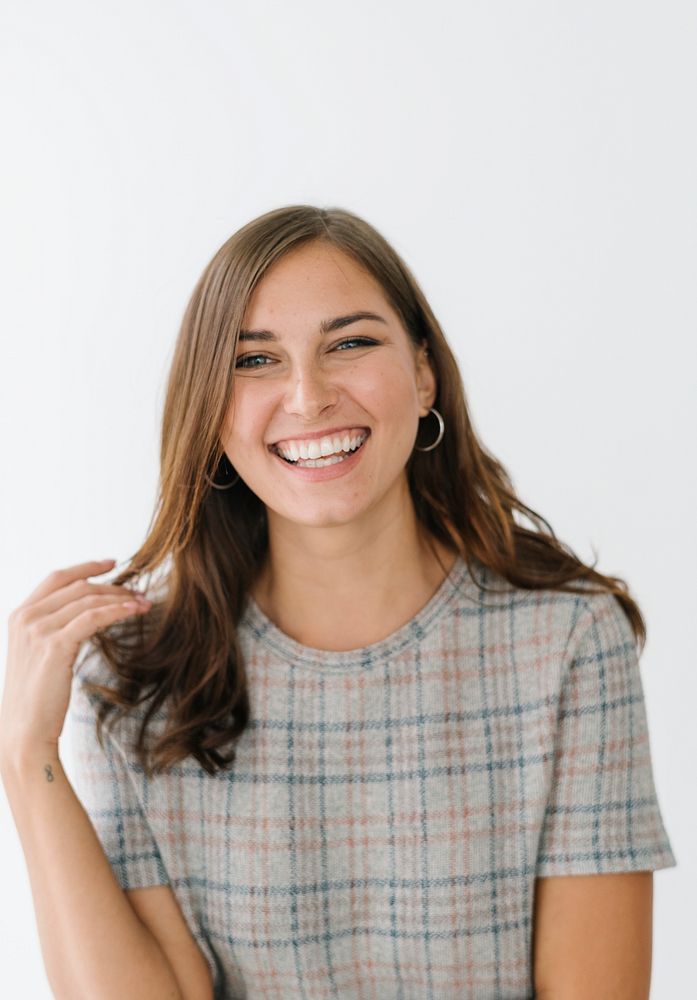 Smiling woman in a gray plaid dress
