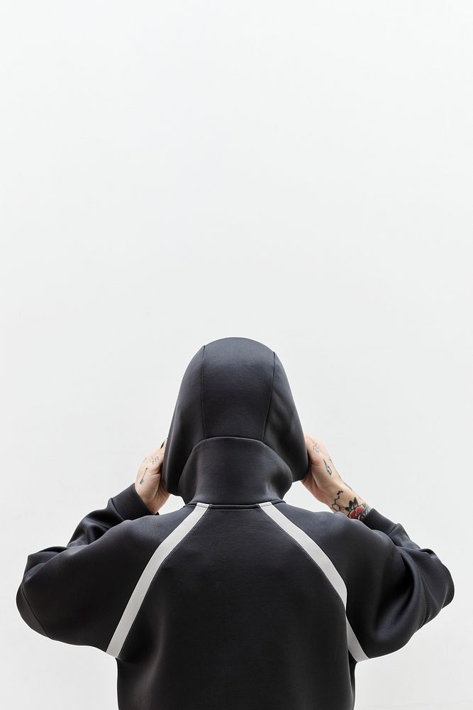 Rearview of a woman covering in a black hoodie
