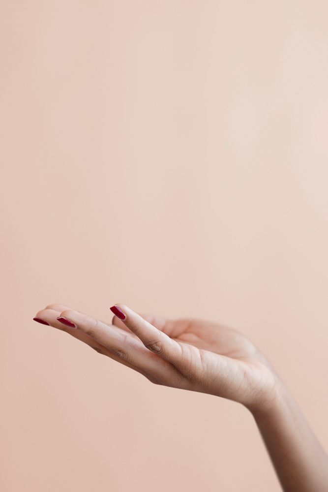 Female hand on a beige background