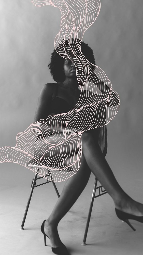 Beautiful black woman with afro hair sitting on a chair mobile phone wallpaper