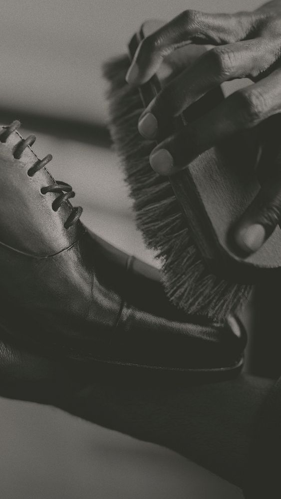 Man applying shoe polish to his brown leather shoes