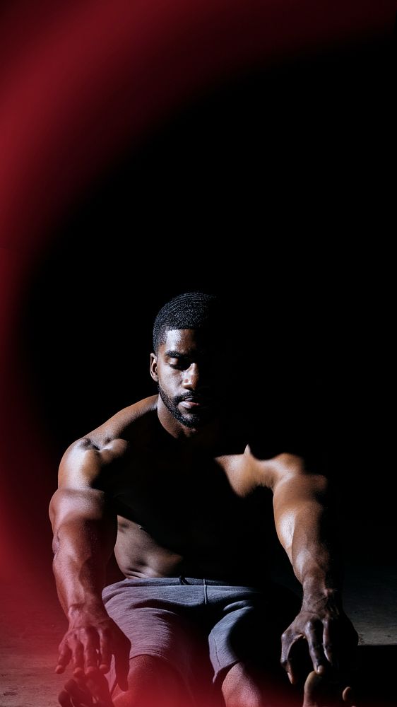 Black man touching his toes mobile phone wallpaper